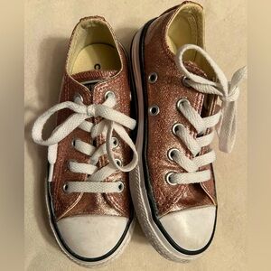 Converse All Star Chuck Taylor’s.  Pink shimmer